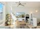 Bright living room featuring a ceiling fan, modern décor, and large windows showcasing a scenic view at 1821 W Vermont Ave, Phoenix, AZ 85015