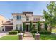 Charming two-story home with a well-manicured front yard and a beautiful brick pathway leading to the entrance at 20311 E Stonecrest Dr, Queen Creek, AZ 85142