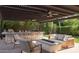 Outdoor living space with a covered patio, bar seating, a cozy fire pit, and comfortable seating at 20311 E Stonecrest Dr, Queen Creek, AZ 85142