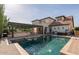 Backyard oasis with a sparkling pool, covered patio with a grill, and lounge chairs for relaxation at 20311 E Stonecrest Dr, Queen Creek, AZ 85142
