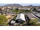 Aerial view of home and backyard with patio, gazebo, desert landscaping, and mountain views in the distance at 2108 E Lindrick Dr, Gilbert, AZ 85298