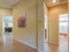 Hallway with an arched doorway and view into the living space and bathroom at 21998 N Greenland Park Dr, Maricopa, AZ 85139