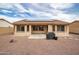 View of the backyard featuring a covered patio and low-maintenance desert landscaping at 22065 W Twilight Trl, Buckeye, AZ 85326