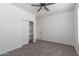 Bedroom featuring sliding closet, carpet and neutral paint with ceiling fan at 22065 W Twilight Trl, Buckeye, AZ 85326
