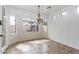 Bright dining room with large windows and a modern chandelier at 22065 W Twilight Trl, Buckeye, AZ 85326