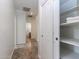 Hallway featuring linen closet, tile flooring and access to bedrooms and bathroom at 22065 W Twilight Trl, Buckeye, AZ 85326