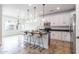 Modern kitchen featuring white cabinetry, stainless steel appliances, and an island with barstool seating at 22065 W Twilight Trl, Buckeye, AZ 85326