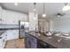 A modern kitchen features stainless steel appliances, granite countertops and a large kitchen island at 22065 W Twilight Trl, Buckeye, AZ 85326
