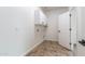 Laundry room with cabinetry, tile flooring and door to hallway at 22065 W Twilight Trl, Buckeye, AZ 85326