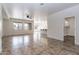 Spacious open-concept layout with tile flooring, ample natural light, and view to kitchen at 22065 W Twilight Trl, Buckeye, AZ 85326