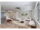 Bright living room featuring tile floors, a comfortable sectional sofa, and modern decor at 22065 W Twilight Trl, Buckeye, AZ 85326