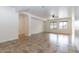 Large living space with neutral tile, a ceiling fan, and bright windows offering natural light at 22065 W Twilight Trl, Buckeye, AZ 85326