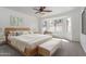 Bright main bedroom with a light wood bed frame and large windows at 22065 W Twilight Trl, Buckeye, AZ 85326