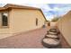 Side yard of house featuring low-maintenance landscaping and block wall for privacy at 22065 W Twilight Trl, Buckeye, AZ 85326