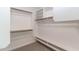 Spacious walk-in closet with wood and white shelving at 22065 W Twilight Trl, Buckeye, AZ 85326