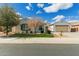 Charming single-story home featuring neat landscaping, blue shutters, and a two-car garage at 2284 N 161St Ave, Goodyear, AZ 85395