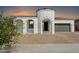 Inviting single-story home featuring a barrel-tile roof, turret entry, desert landscaping, and a convenient two-car garage at 22902 E Arroyo Verde Dr, Queen Creek, AZ 85142