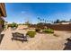 Relaxing backyard featuring decorative rock, pavers, bench and lovely landscaping at 23935 S Sunvista Dr, Sun Lakes, AZ 85248