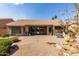 Paver and rock landscaping in a backyard featuring a patio and seating area at 23935 S Sunvista Dr, Sun Lakes, AZ 85248
