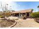 An entertainer's backyard with an outdoor kitchen and barbecue with lush rock landscaping at 23935 S Sunvista Dr, Sun Lakes, AZ 85248