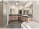 Spacious primary bathroom featuring double sinks, tile floors, and separate glass shower and tub at 23935 S Sunvista Dr, Sun Lakes, AZ 85248