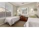 Cozy bedroom featuring two twin beds, neutral walls, and a window for natural light at 23935 S Sunvista Dr, Sun Lakes, AZ 85248