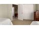 Bedroom with white trim, closet, and connected bath at 23935 S Sunvista Dr, Sun Lakes, AZ 85248