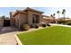 Lovely home featuring desert landscaping, a well-maintained lawn, and a neutral color scheme at 23935 S Sunvista Dr, Sun Lakes, AZ 85248