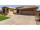 Attractive home featuring a multi-car garage, long driveway, and desert-friendly landscaping at 23935 S Sunvista Dr, Sun Lakes, AZ 85248