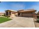 Spacious home with a multi-car garage, long driveway, and desert-friendly landscaping at 23935 S Sunvista Dr, Sun Lakes, AZ 85248