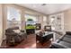 Inviting living room with hardwood floors, fireplace, and access to patio at 23935 S Sunvista Dr, Sun Lakes, AZ 85248