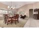 Open-concept living and dining area with vaulted ceilings and abundant natural light at 23935 S Sunvista Dr, Sun Lakes, AZ 85248