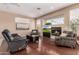 Bright living room with hardwood floors, fireplace, and comfortable seating at 23935 S Sunvista Dr, Sun Lakes, AZ 85248
