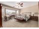 Serene primary bedroom with a ceiling fan and a large window at 23935 S Sunvista Dr, Sun Lakes, AZ 85248