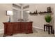 Bright office space with a large wooden desk, shelving and a plant, creating a perfect work-from-home atmosphere at 23935 S Sunvista Dr, Sun Lakes, AZ 85248