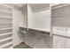 Walk-in closet with built-in shelving, hanging rods, and carpet floors at 23935 S Sunvista Dr, Sun Lakes, AZ 85248