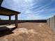 Large backyard with a covered patio is ready for landscaping at 25161 W Wayland Dr, Buckeye, AZ 85326