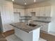 Bright kitchen features white cabinets, granite countertops and a center island with a sink at 25161 W Wayland Dr, Buckeye, AZ 85326