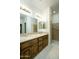 Bathroom featuring double sink vanity, granite counters, tile flooring and walk in shower with safety bar at 2662 S Springwood Blvd # 467, Mesa, AZ 85209