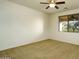 Neutral bedroom with carpeted floors, ceiling fan, window overlooking landscaped exterior, and closet at 2662 S Springwood Blvd # 467, Mesa, AZ 85209