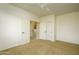 Bedroom featuring carpet floors, ceiling fan, closet, and doors to laundry room at 2662 S Springwood Blvd # 467, Mesa, AZ 85209