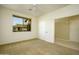 Well-lit bedroom with neutral carpet and wall paint and a large window with exterior home view at 2662 S Springwood Blvd # 467, Mesa, AZ 85209