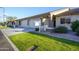 Landscaped single-story home with well-kept lawn, two-car garage, and decorative stone pillars at entry at 2662 S Springwood Blvd # 467, Mesa, AZ 85209