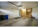Garage featuring storage cabinets, organizational peg board, and two waste containers at 2662 S Springwood Blvd # 467, Mesa, AZ 85209