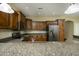 Modern kitchen with dark wood cabinets, granite countertops, stainless steel appliances, and ample counter space at 2662 S Springwood Blvd # 467, Mesa, AZ 85209