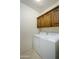 Laundry room featuring tile floor, overhead cabinet, and appliances at 2662 S Springwood Blvd # 467, Mesa, AZ 85209