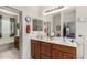 Bathroom featuring double sinks, vanity, large mirror and a separate bath and shower at 273 S 152Nd Ave, Goodyear, AZ 85338