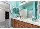 Bright bathroom featuring double mirrors, wooden cabinets, and a white countertop, offering a refreshing and functional space at 273 S 152Nd Ave, Goodyear, AZ 85338
