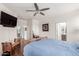 Spacious bedroom with wood-look flooring, a ceiling fan, and ensuite bathroom at 273 S 152Nd Ave, Goodyear, AZ 85338