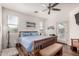 Bright bedroom features natural light, ceiling fan, and wood-look flooring at 273 S 152Nd Ave, Goodyear, AZ 85338